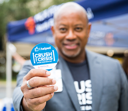 Crush the Crisis promo item held by Chief Medical Officer at the event
