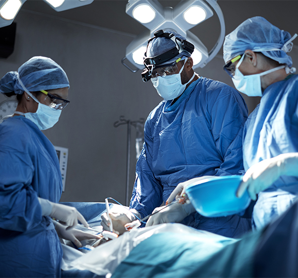 A team of surgeons performing a surgery in an operating room