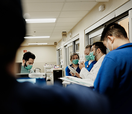 A group of doctors and nurses meet before starting their shift
