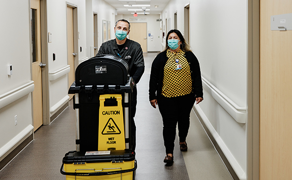 Juan Guerrero, Environmental Services Aide; Marisa Silva, Assistant Director, EVS walk the halls at Sunrise Hospital and Medical Center
